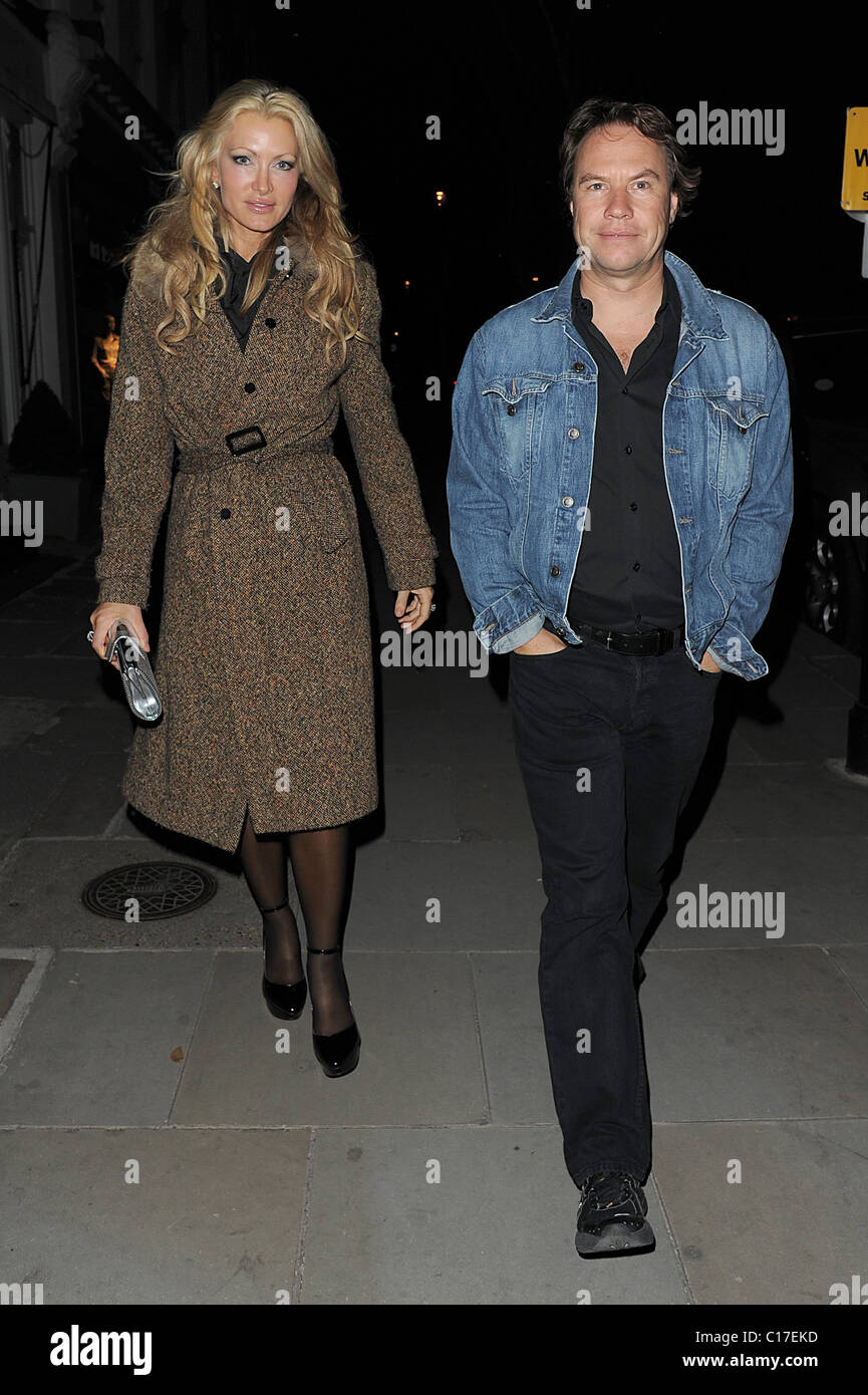 Caprice Bourret and a male companion leaving Beach Blanket Babylon, in