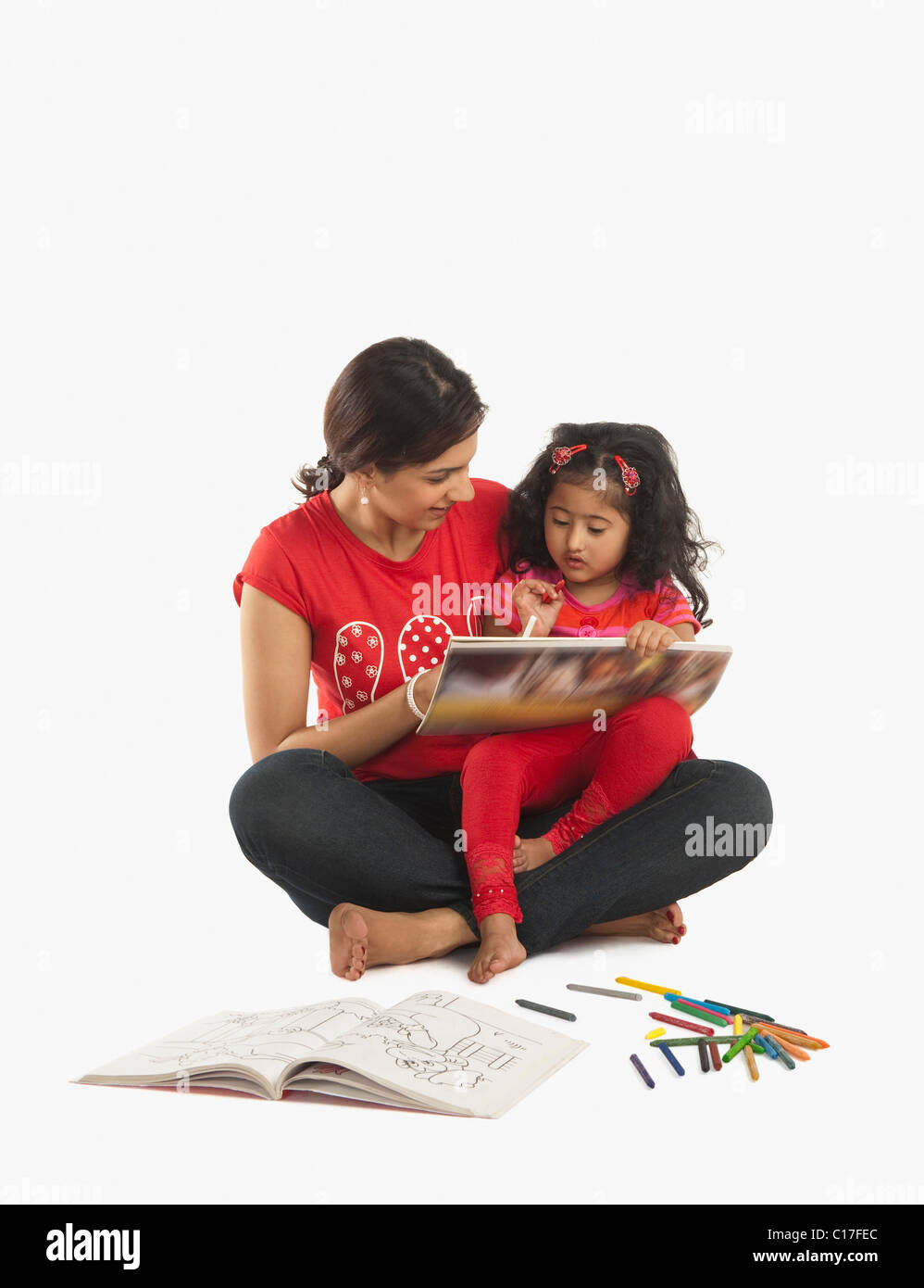 girl sitting on her mother s lap and drawing a picture stock photo alamy