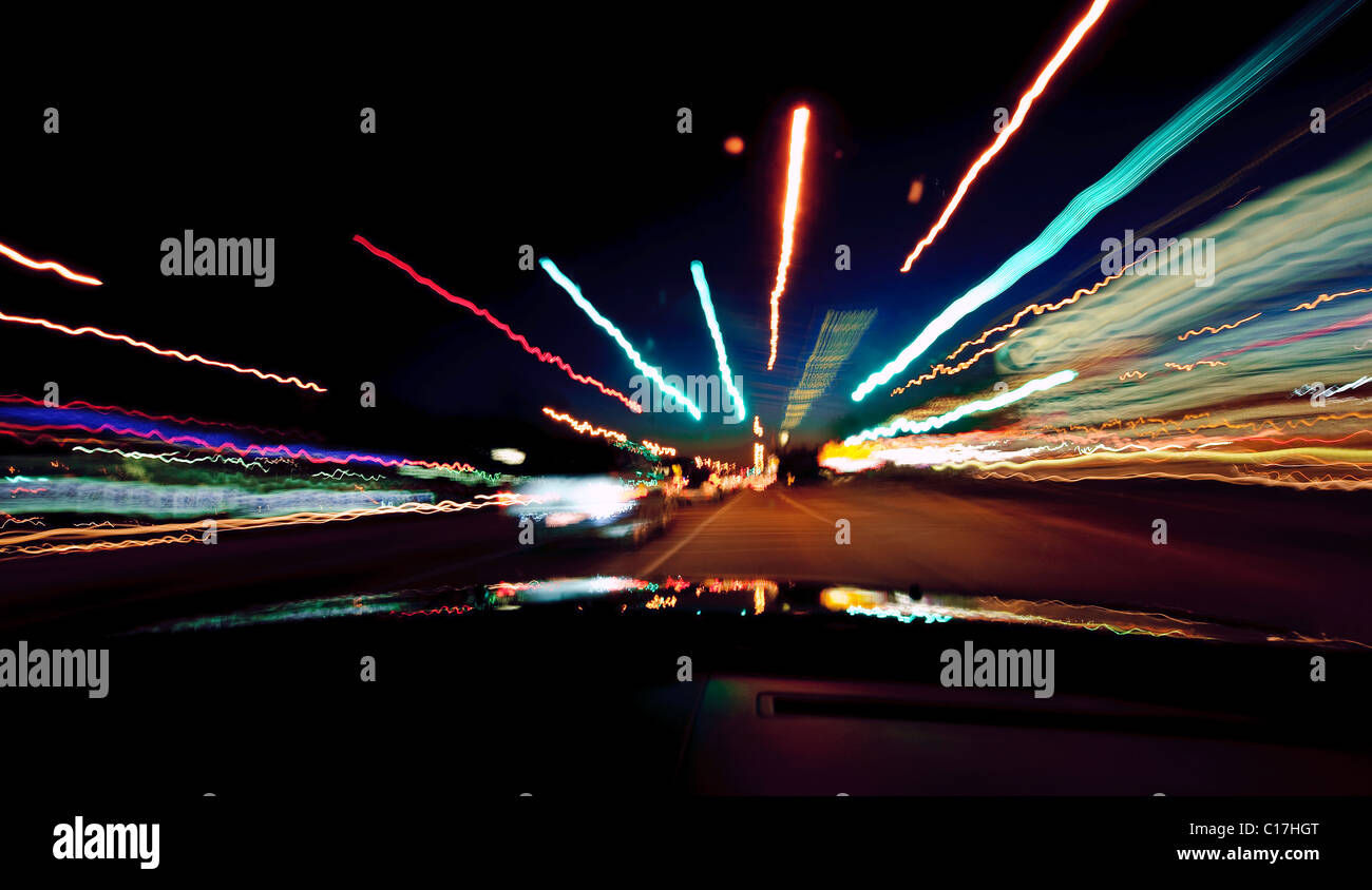 motion blur on street lights taken from inside a car at night Stock Photo