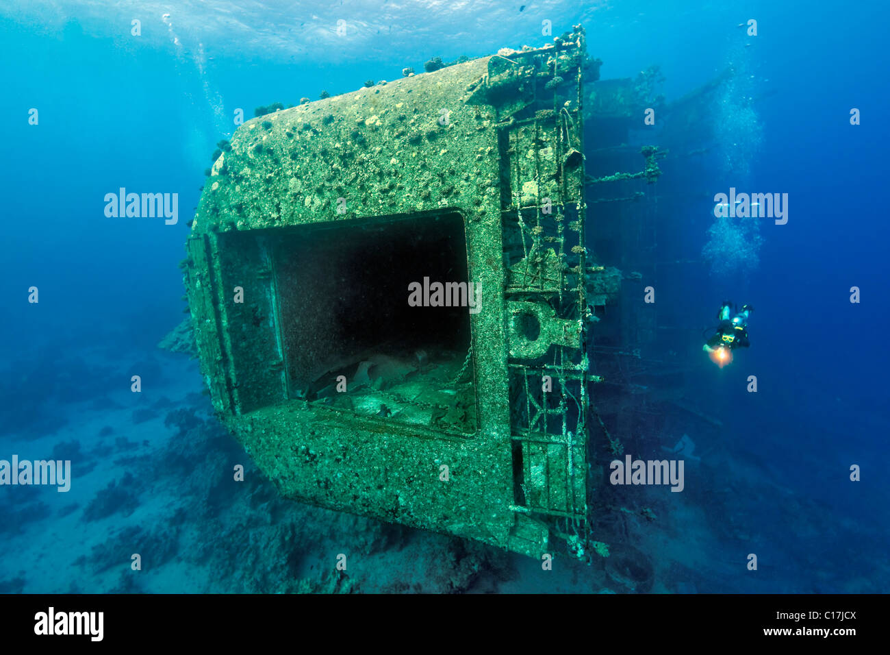 A scuba diver examines the stern of the Salem Express Ferry shipwreck which lies on Hyndman Reef in the Egyptian Red Sea. Stock Photo