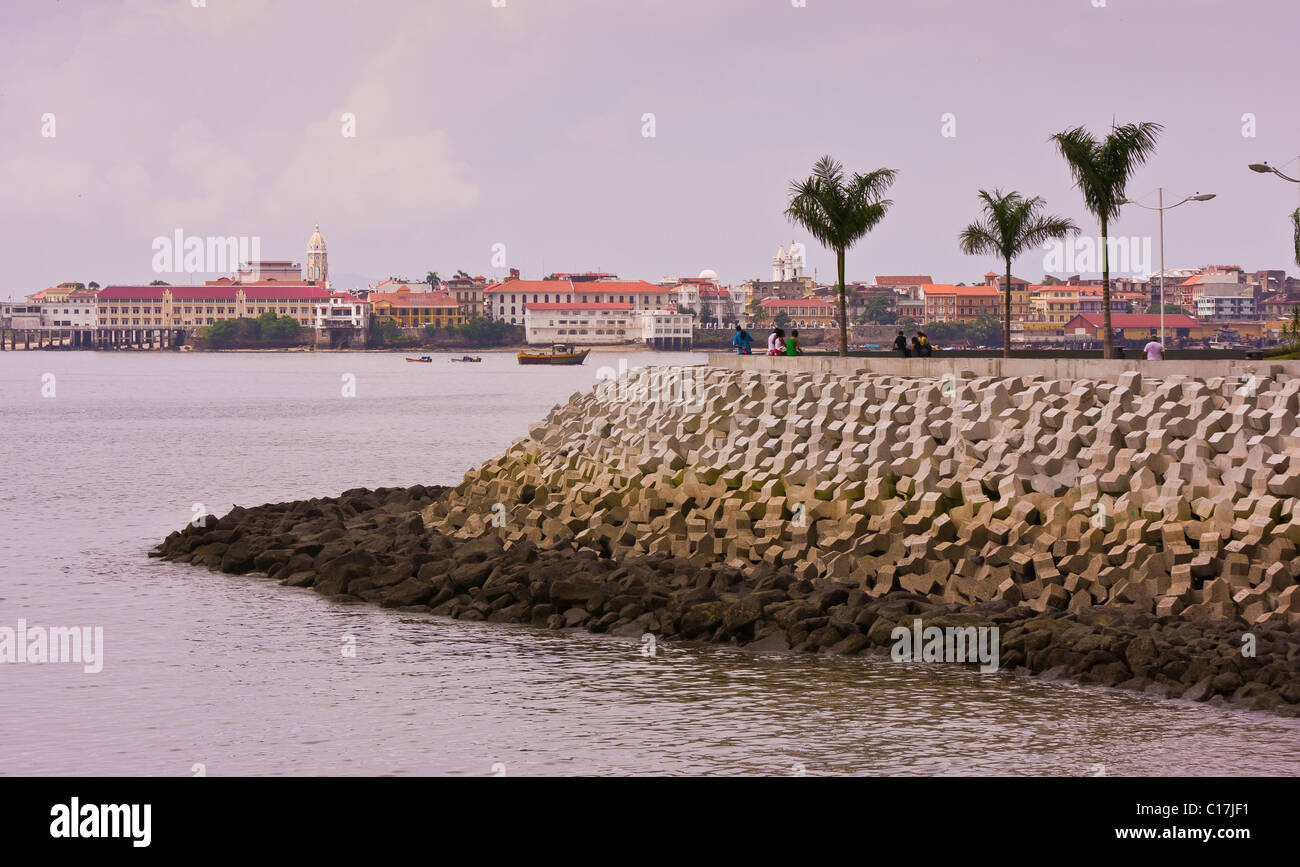 PANAMA CITY, PANAMA - seawall of riprap on Panama Bay, with Casco Viejo in distance. Stock Photo