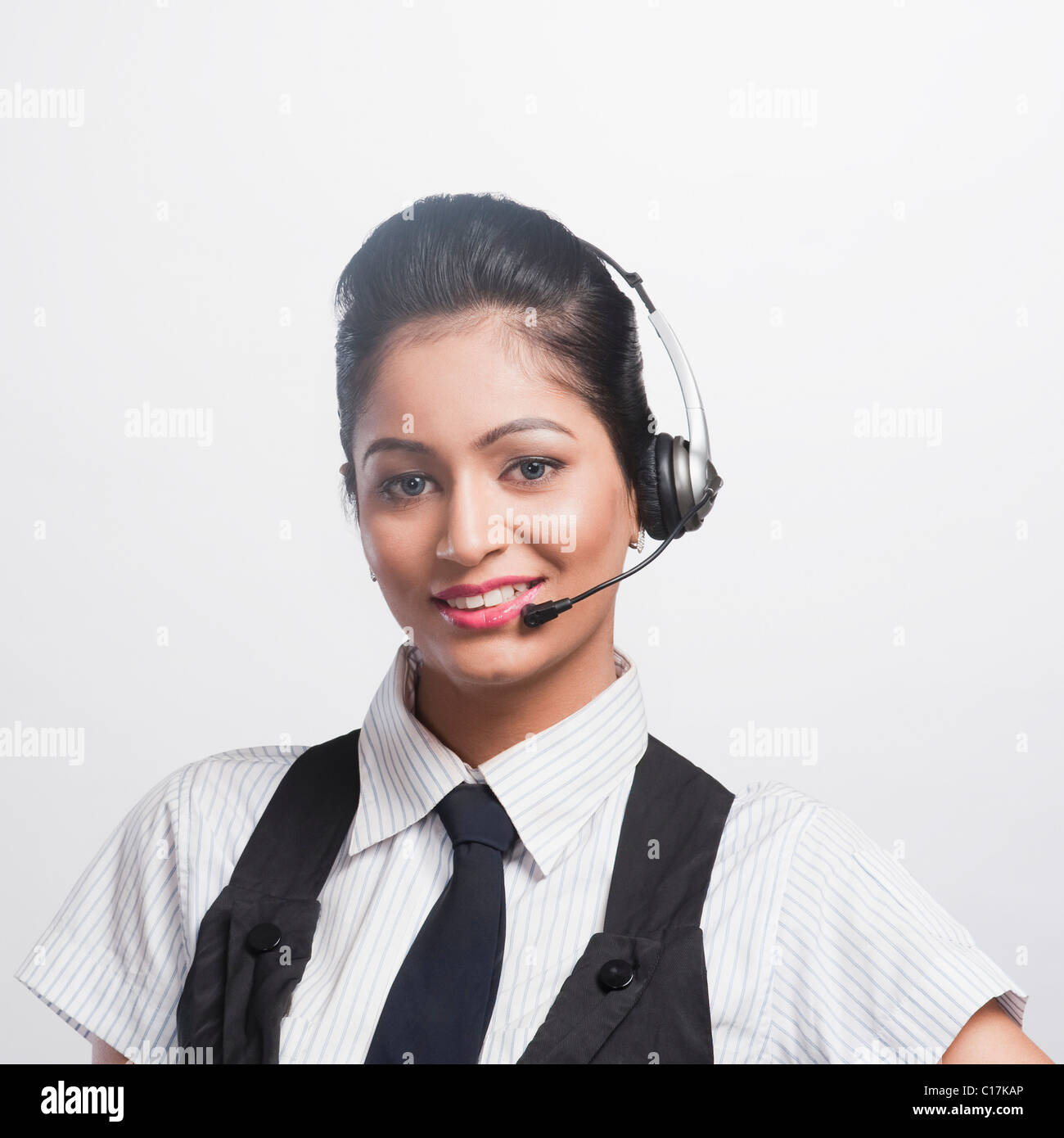 Portrait of a female customer service representative wearing a headset ...