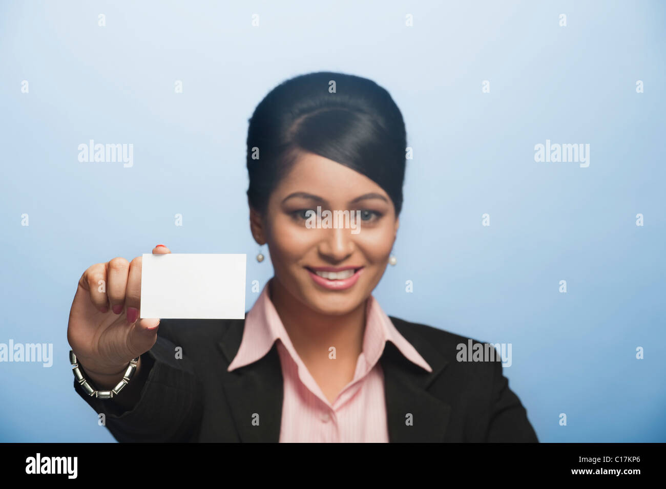 Portrait of a businesswoman holding a blank card Stock Photo