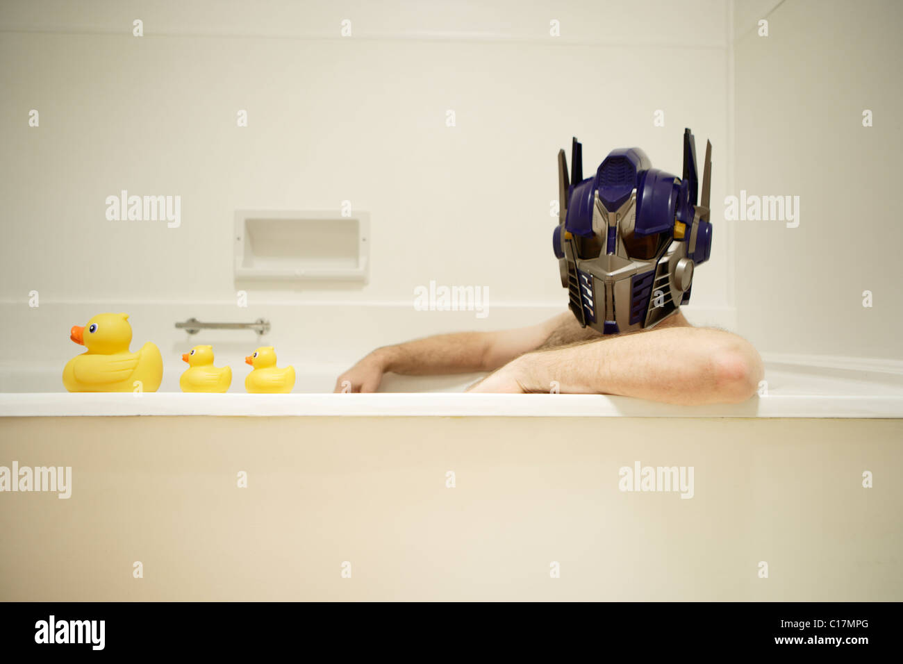 Man wears toy helmet of the transformer robot Optimus Prime, a