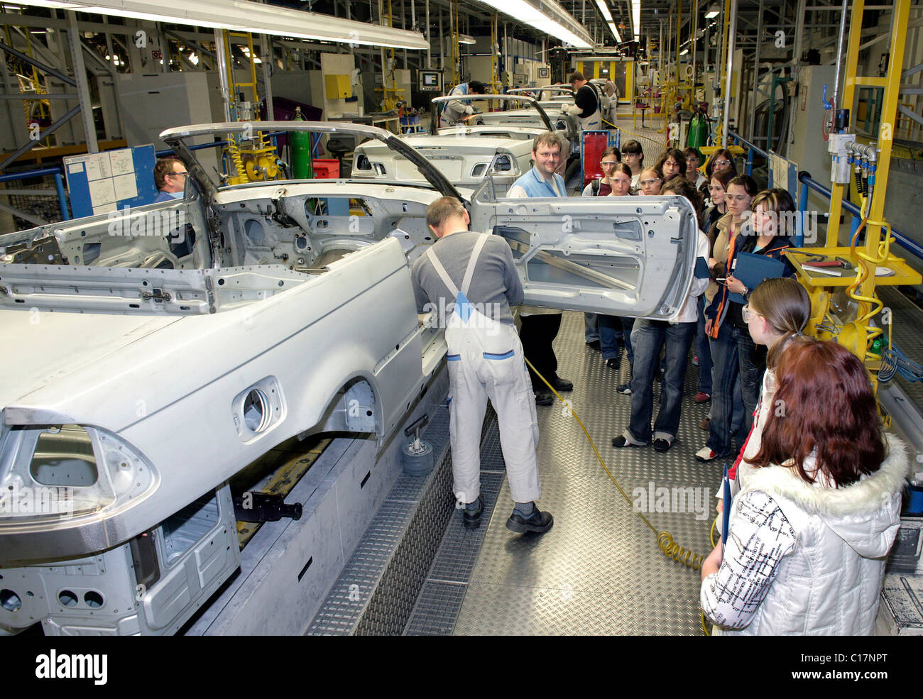 Girls students during the Girl's Day on April 27, 2006 observing chassis production of a Cabriolet at the BMW AG production Stock Photo