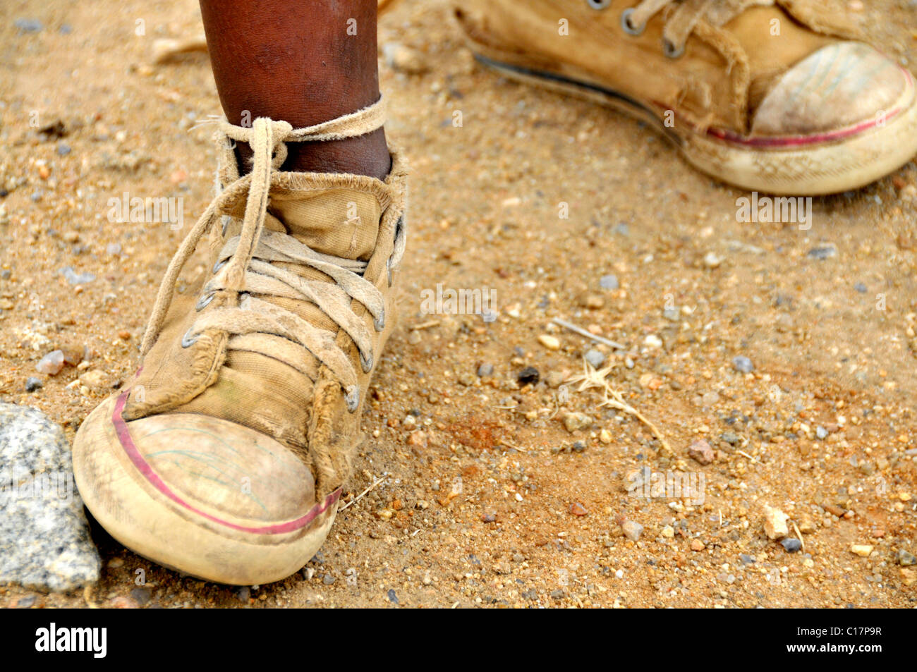 Young black African's football shoes, Swaziland, South Africa, Africa Stock Photo