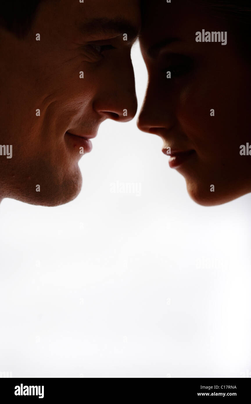 Lovers looking into each other's eyes, backlight Stock Photo