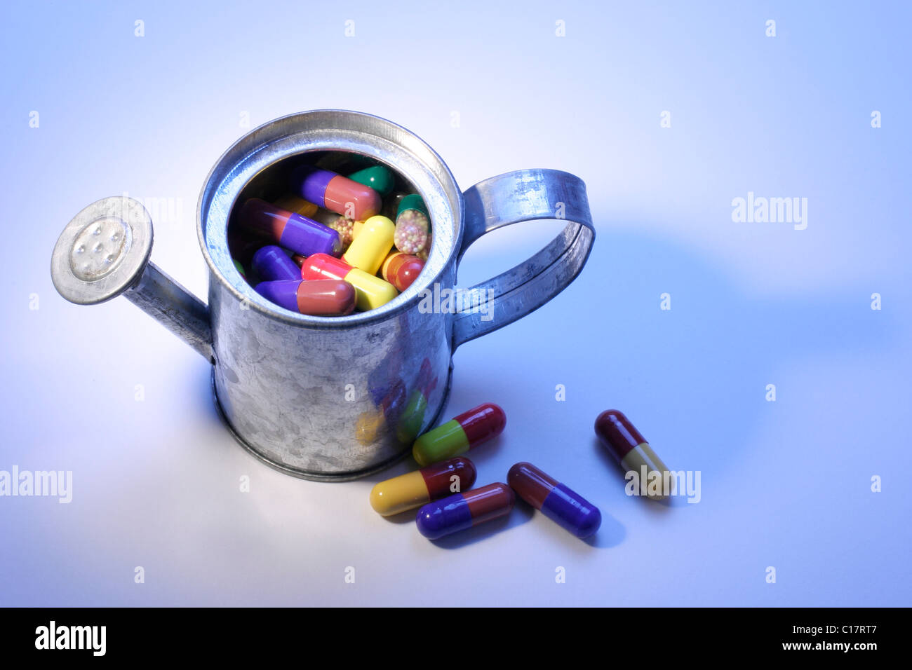 Watering can and pills, capsules Stock Photo Alamy