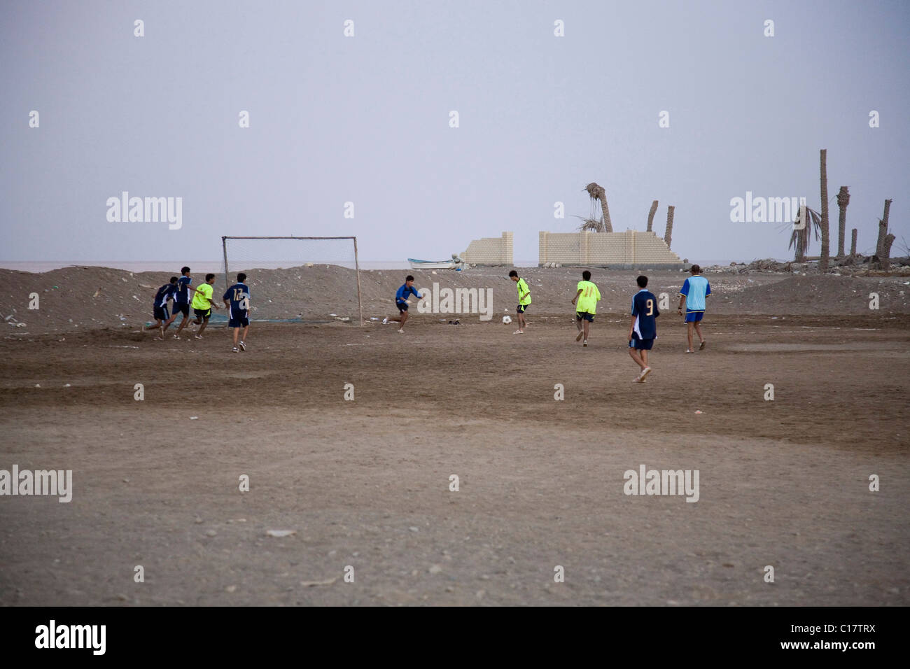 Playing soccer in desert dust beneath the Rifa-Fort, Rifa, Kingdom