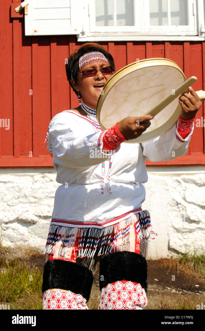 Inuit wearing a traditional costume, folklore in front of a museum in
