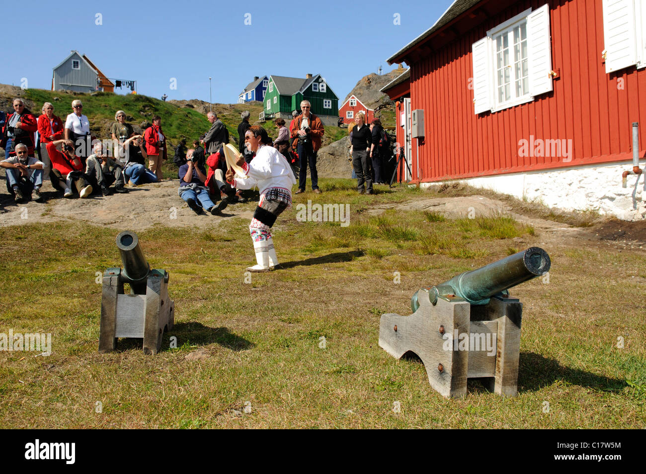 Inuit wearing a traditional costume, folklore in front of a museum in Tasiilaq, Ammassalik, East Greenland, Greenland Stock Photo