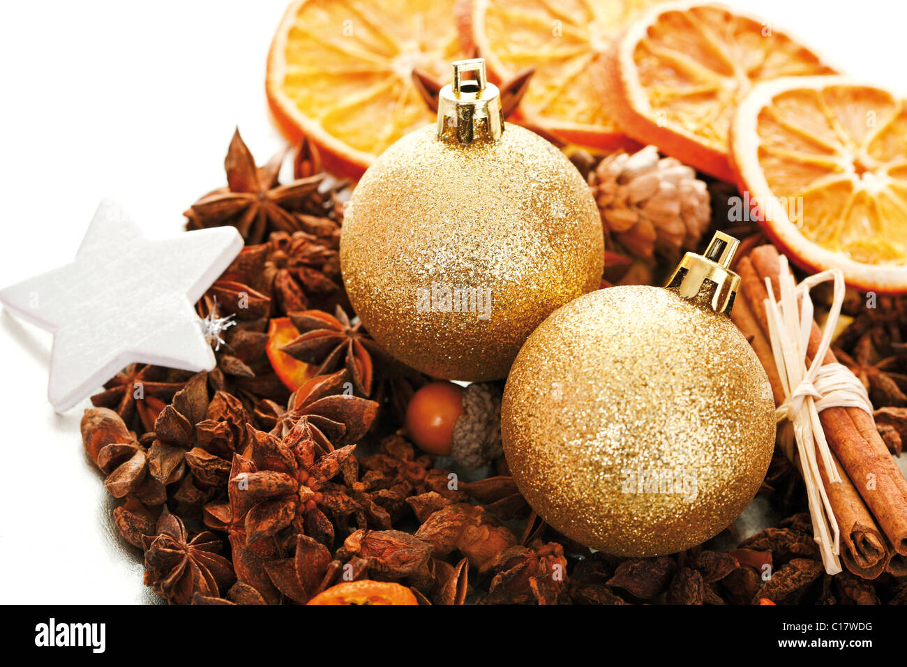 Christmas platter with decorative star, cinnamon sticks, star anise, Christmas tree balls and dried orange slices Stock Photo