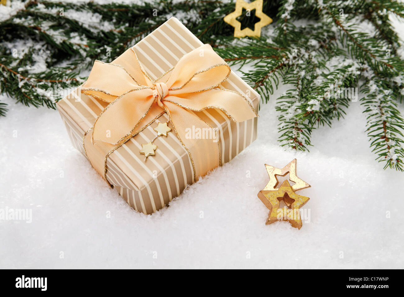 Christmas present and decorations on snow with branches of fir Stock Photo
