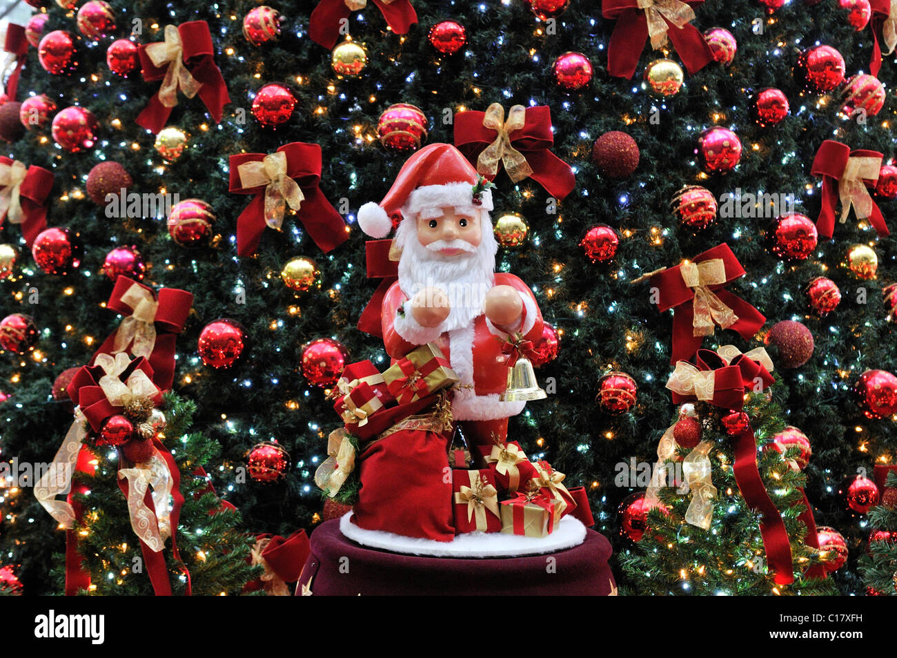 Santa Claus figure with a decorated Christmas tree at back, Sao Paulo, Brazil, South America Stock Photo