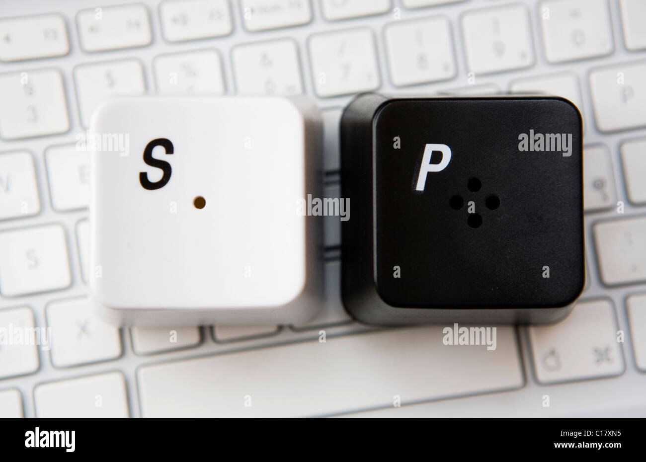 Salt and pepper shakers in the shape of over sized computer keys, designed by James Burgess Stock Photo