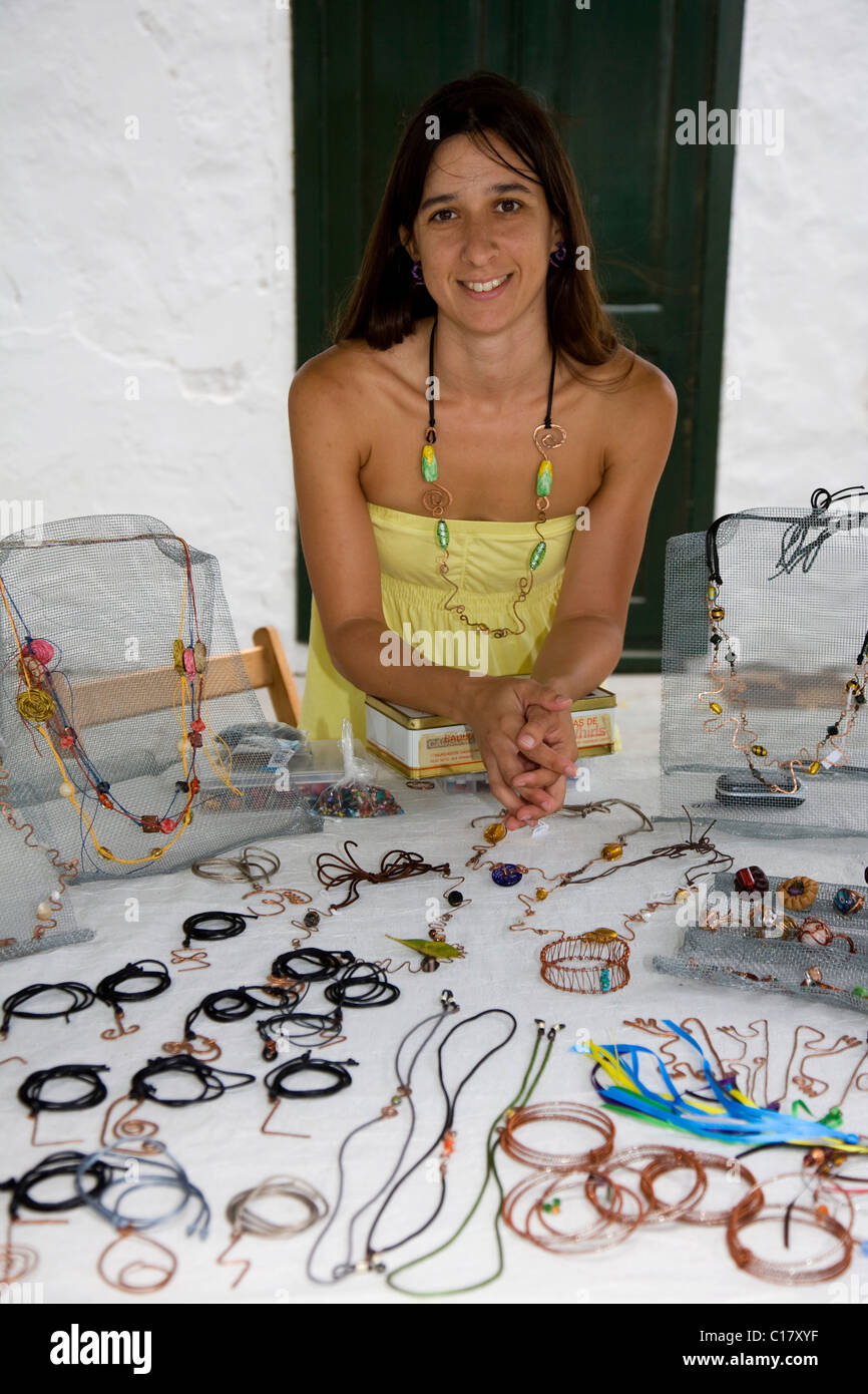 Woman selling jewelery made of copper and lava, Damaris Martin design, Saturday craft market in Haria, Lanzarote, Canary Islands Stock Photo