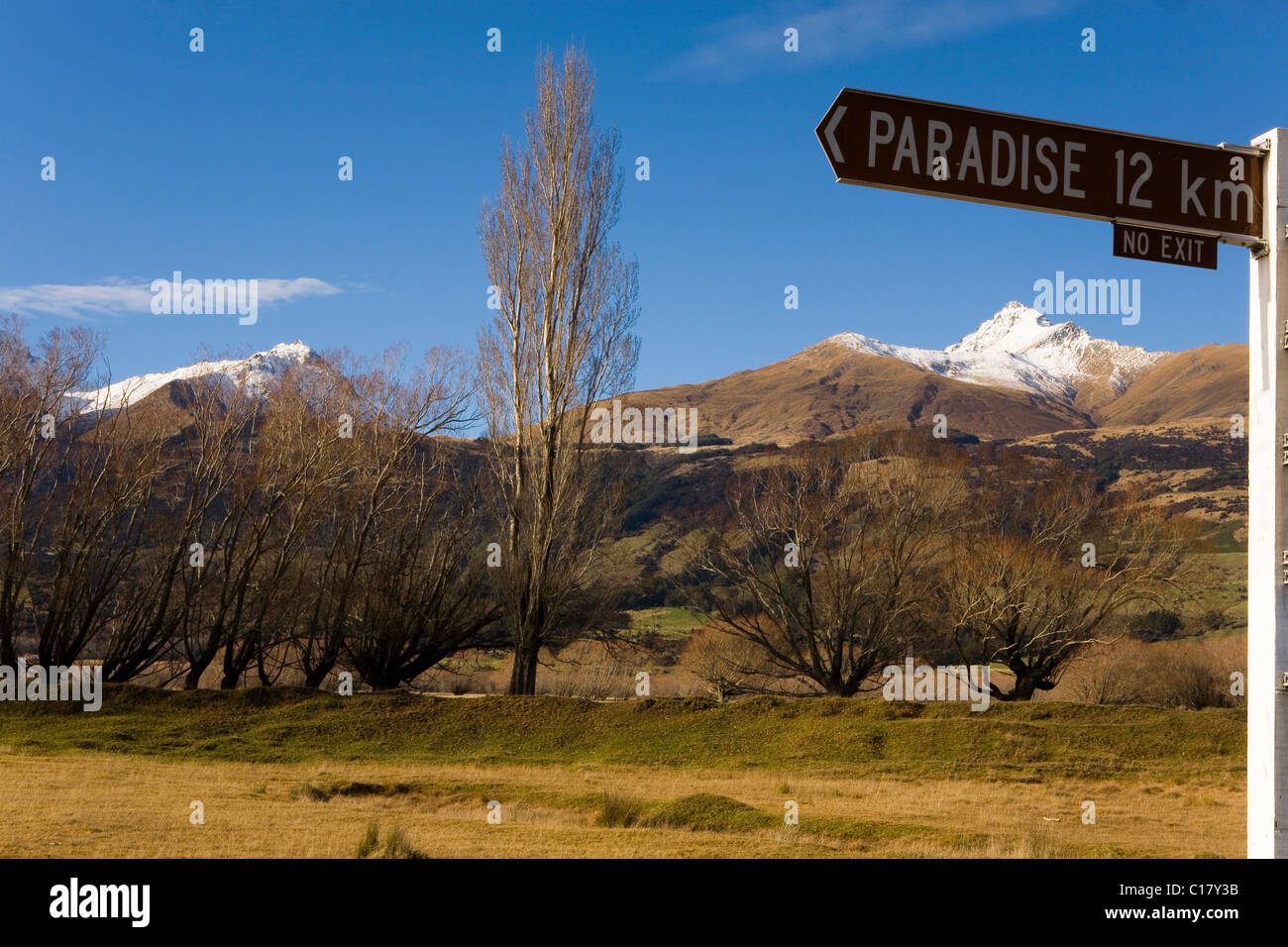 Signpost to the village of Paradise, with a view of Stair Peak, Otago, South Island, New Zealand Stock Photo