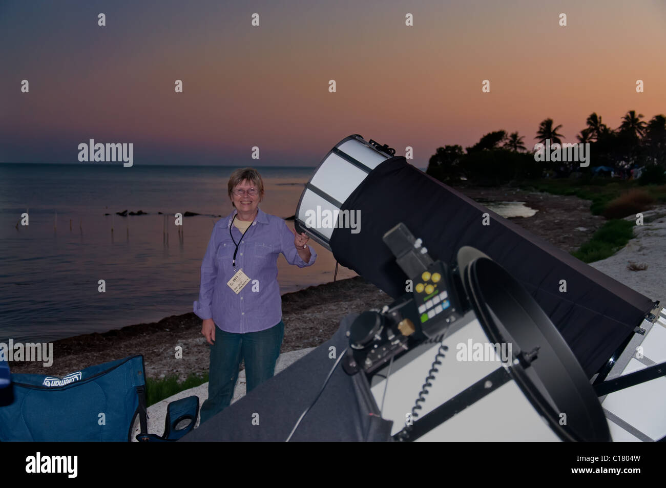 Mature female amateur astronomer with her telescopes at a star Party in the Florida Keys Stock Photo