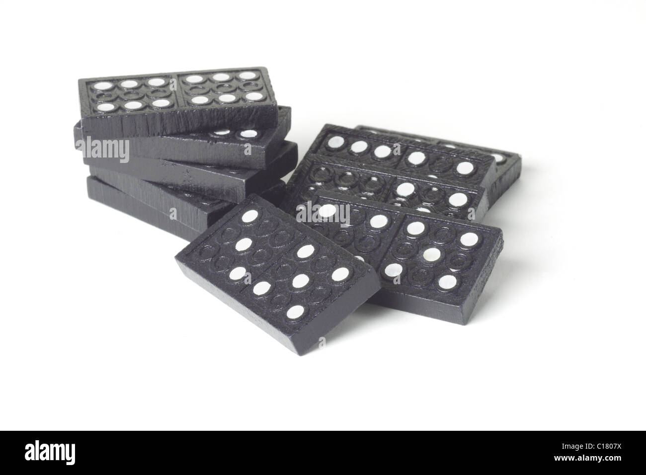Black wooden domino blocks on white background Stock Photo