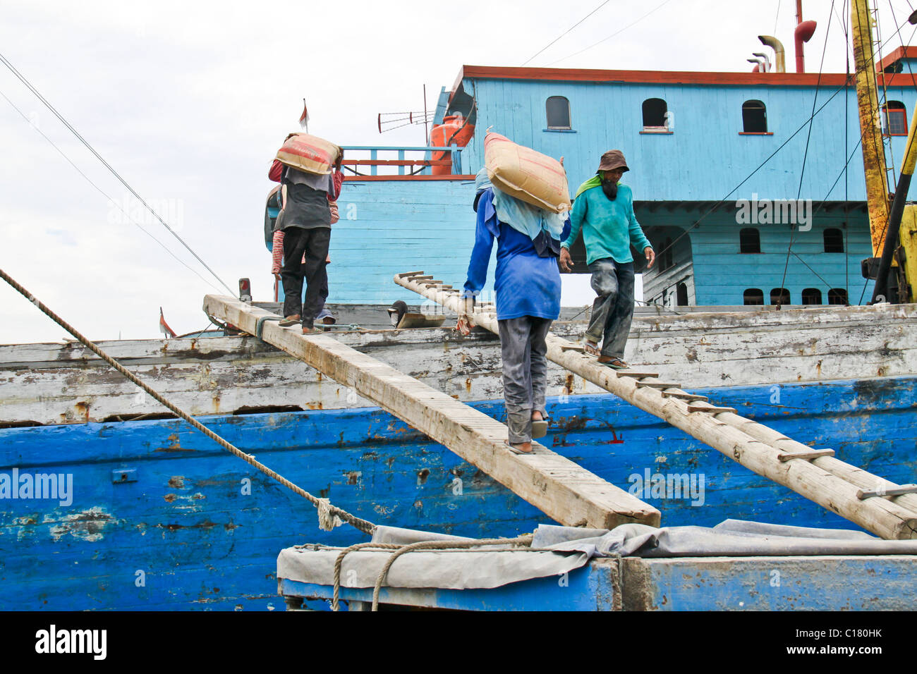 Workers on gangplank load ship in Sunda Kelapa - the old port of