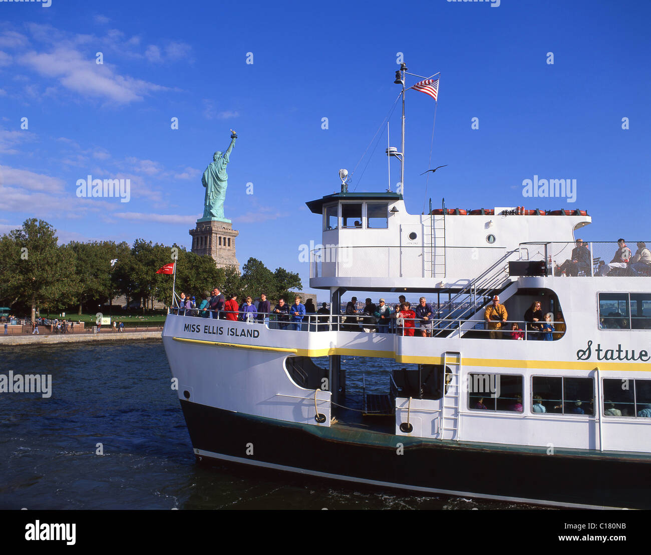 Miss Ellis Island Ferry passing Statue of Liberty National Monument, Liberty Island, New York, New York State, United States of America Stock Photo