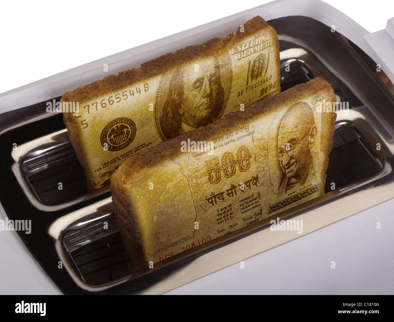 Toast of US currency popping out from a toaster Stock Photo