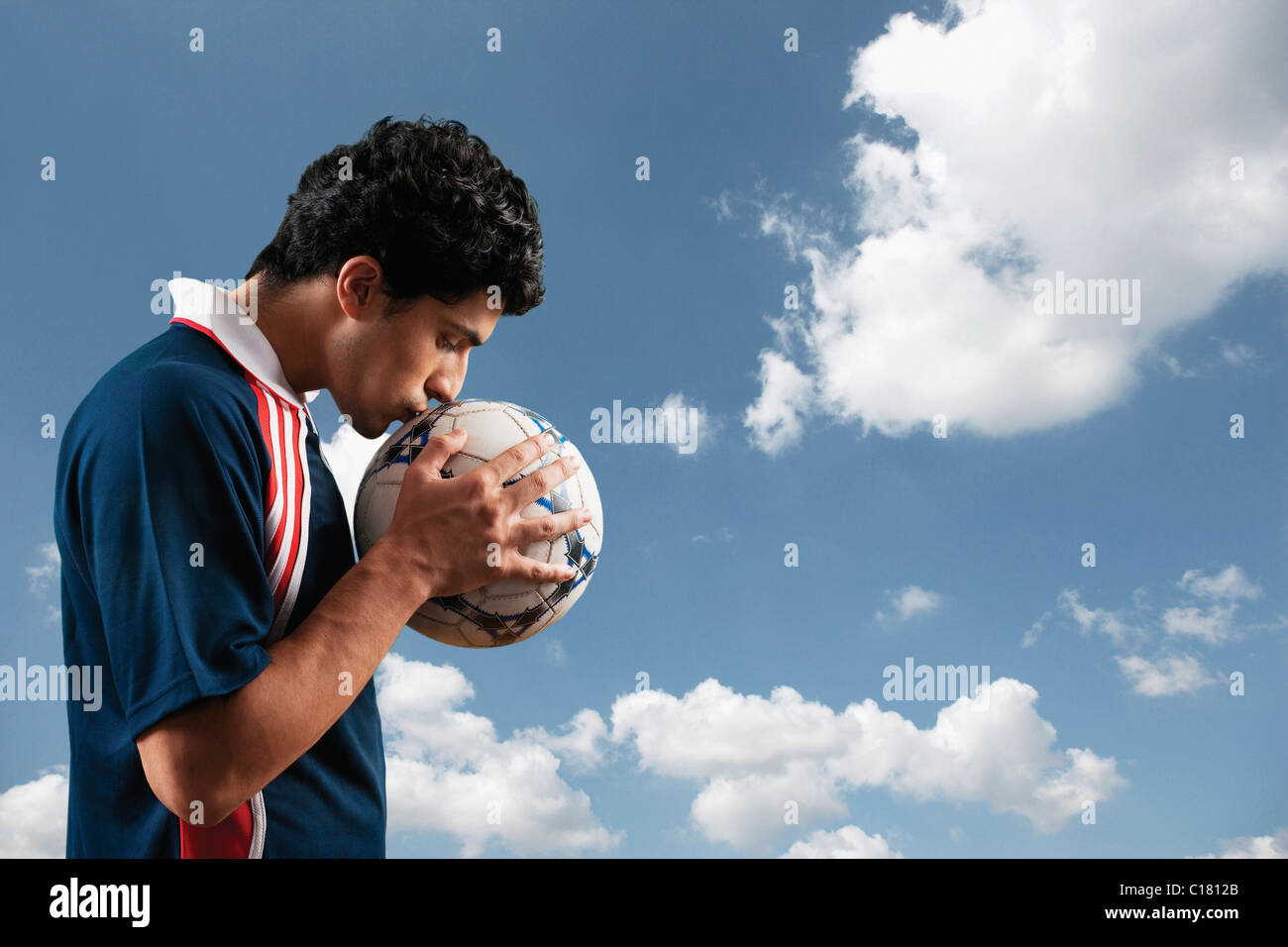 Soccer player kissing a soccer ball Stock Photo