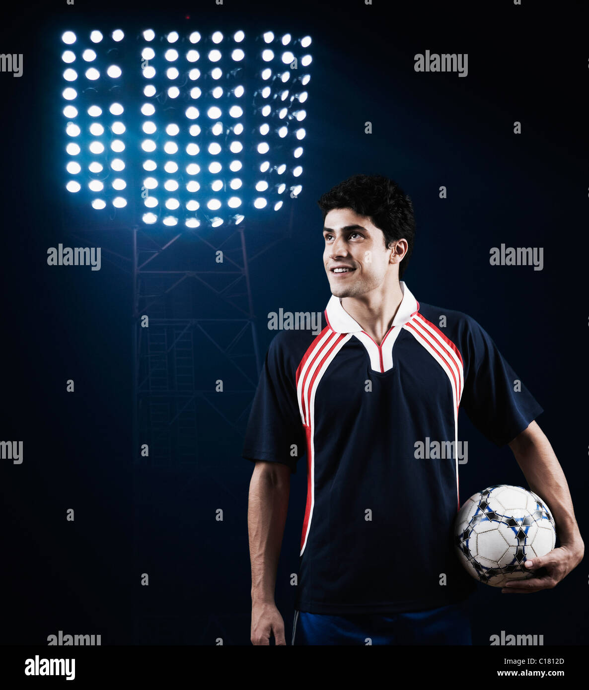 Soccer player holding a soccer ball and smiling Stock Photo