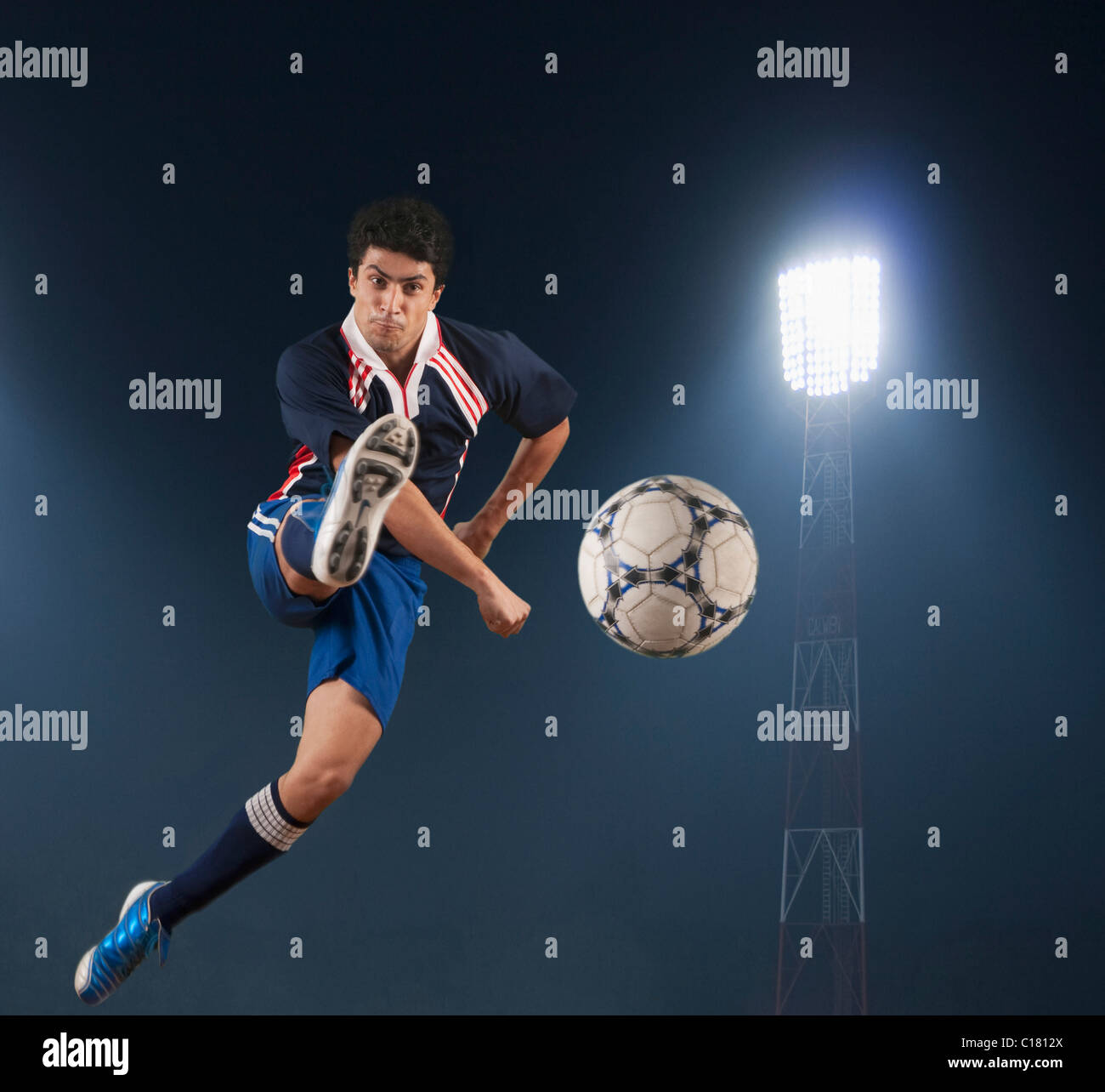 Soccer player kicking a soccer ball Stock Photo