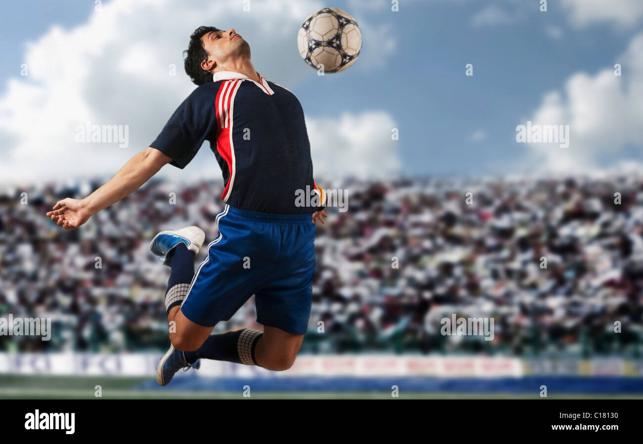Soccer player trapping a soccer ball on chest Stock Photo Alamy