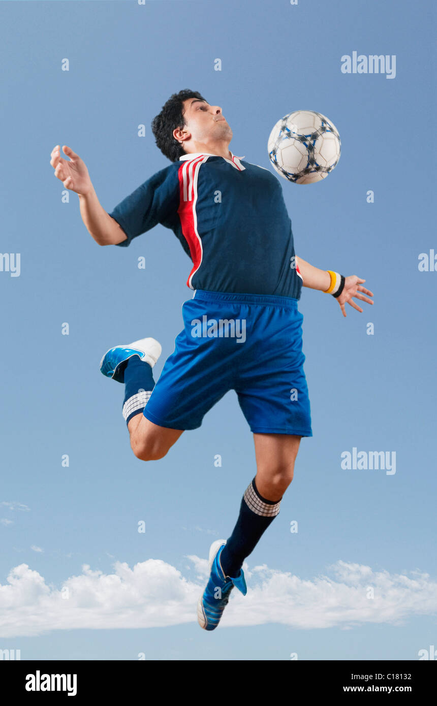 Soccer player trapping a soccer ball on chest Stock Photo