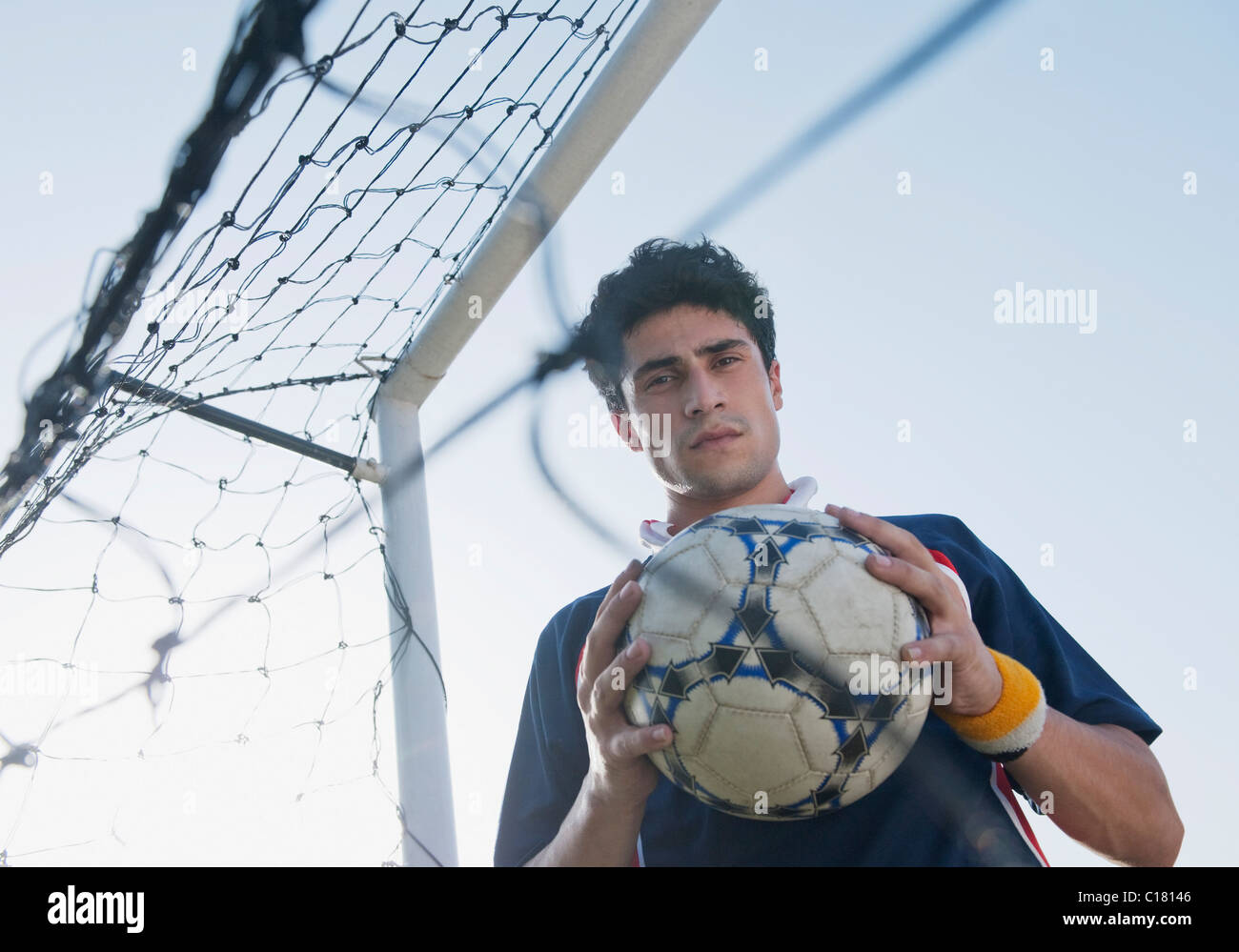 Soccer player holding a soccer ball Stock Photo