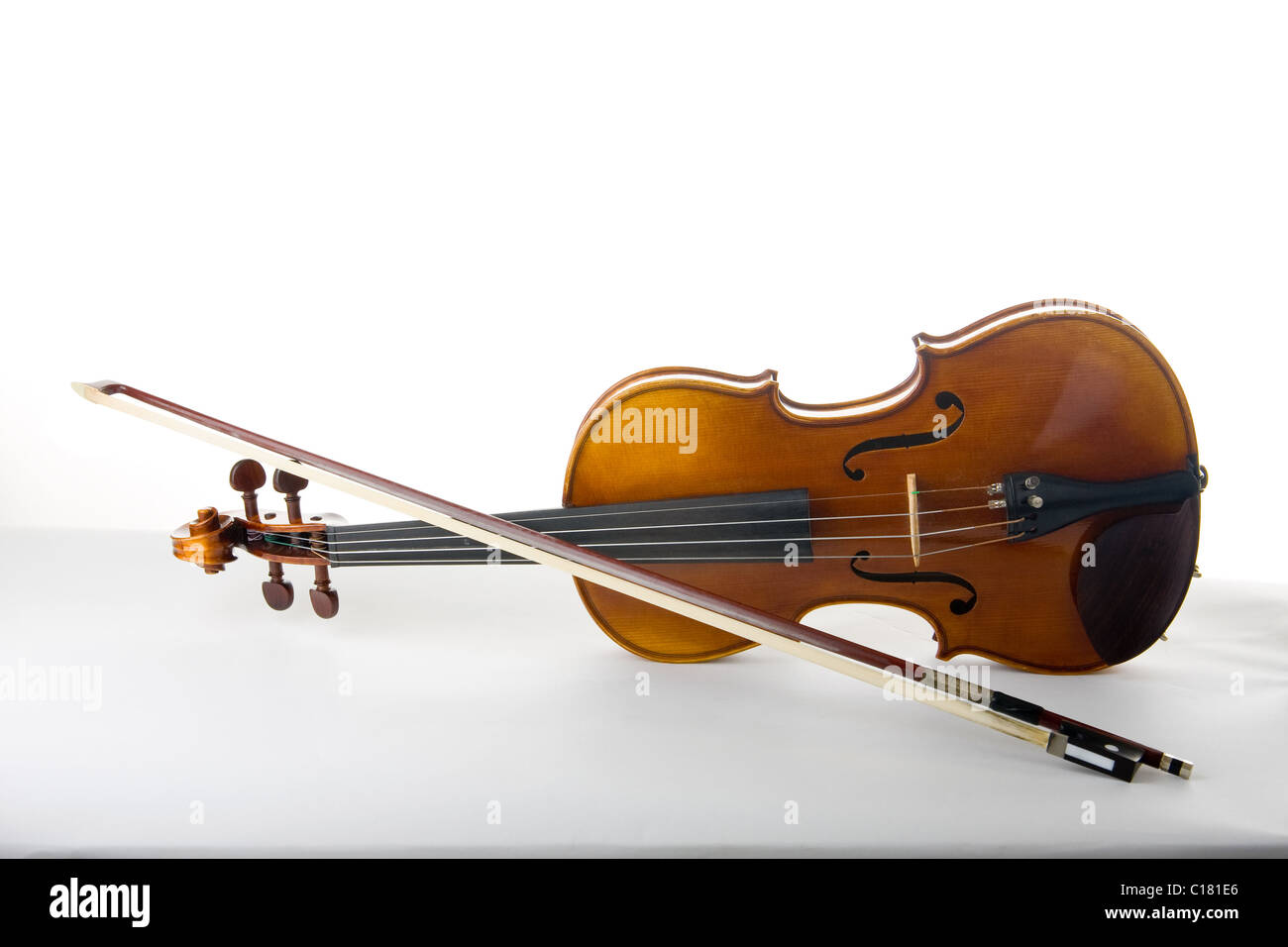 Classical violin or fiddle and bow on its side. Stock Photo