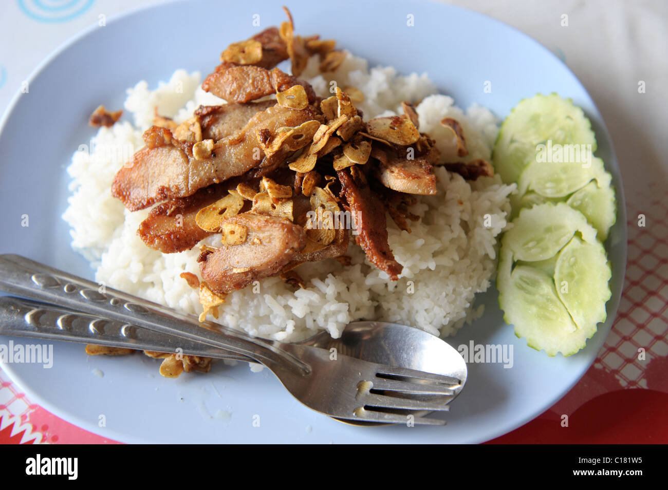 deep fried pork with garlic top on rice, thai cuisine at its very best