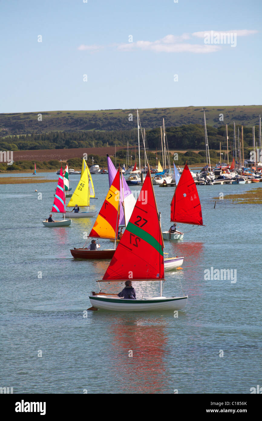 Colourful dinghies being raced at Yarmouth, Isle of Wight, Hampshire UK