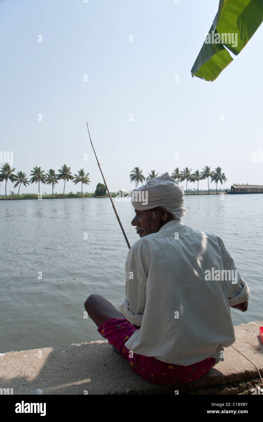 Fisherman under a palm tree Stock Photo