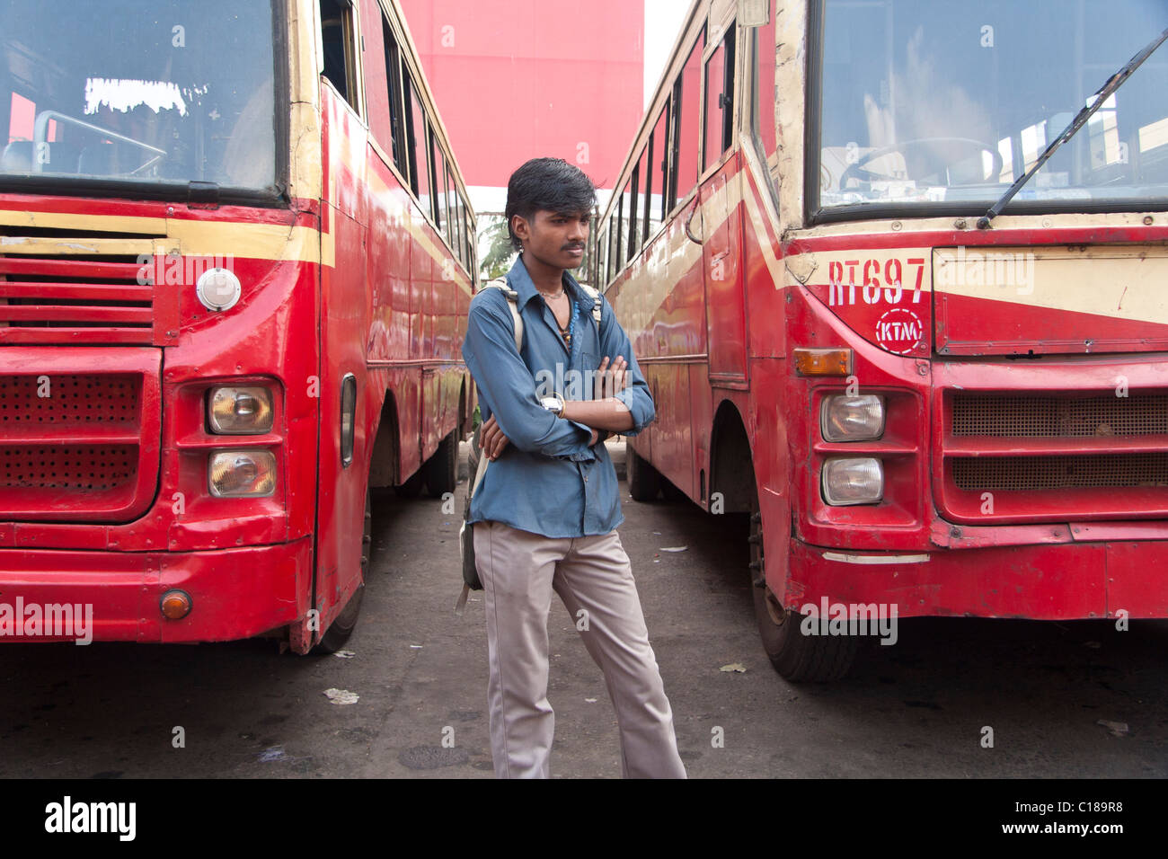 India boy waiting for the bus at the bus station Stock Photo