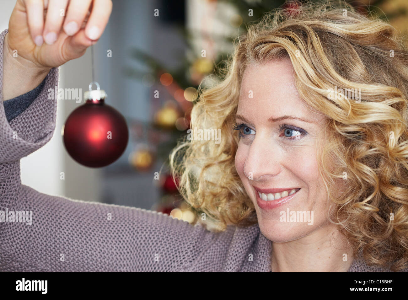 Woman looking at Christmas ball Stock Photo