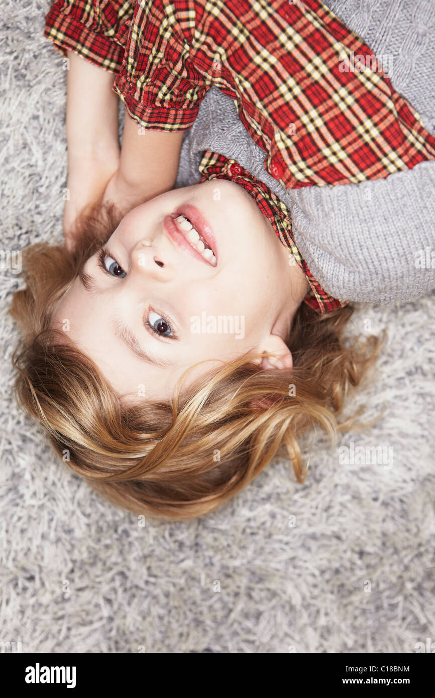 Girl lying on carpet Stock Photo Alamy