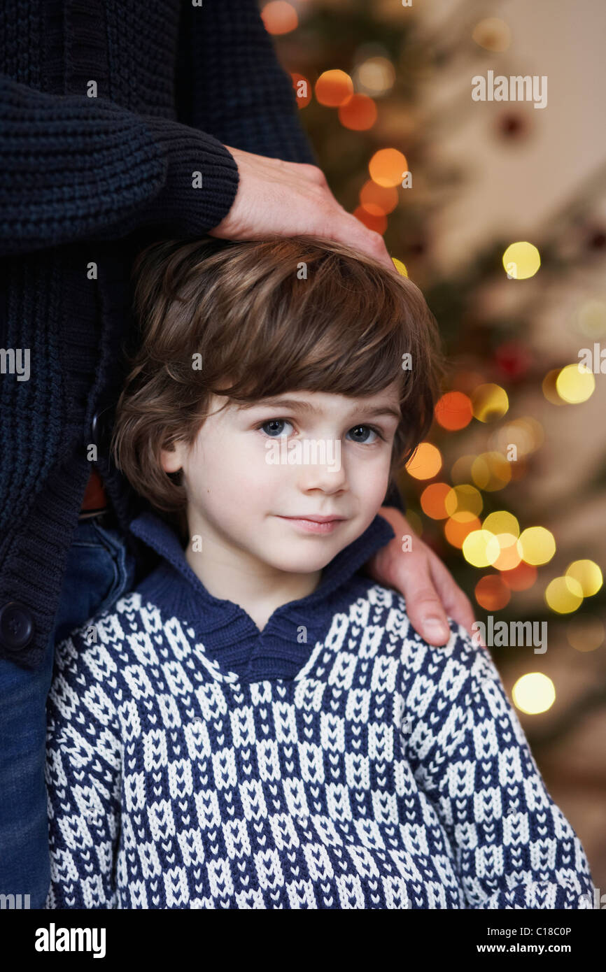 Boy leaning at father Stock Photo
