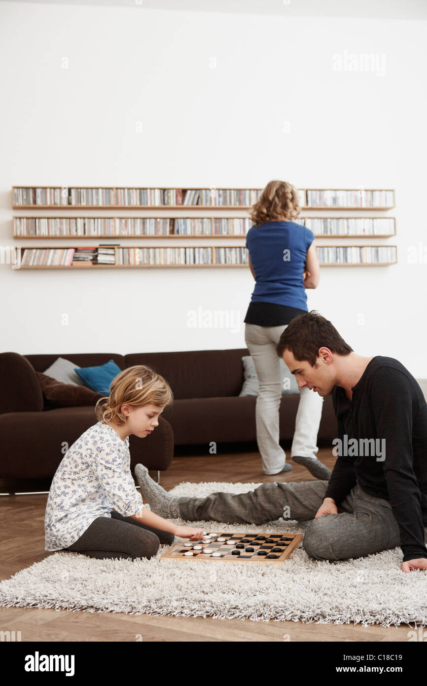 Father and daughter playing checkers Stock Photo