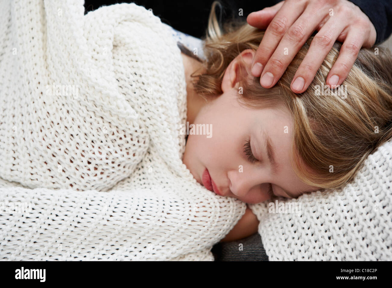 Girl sleeping under blanket Stock Photo