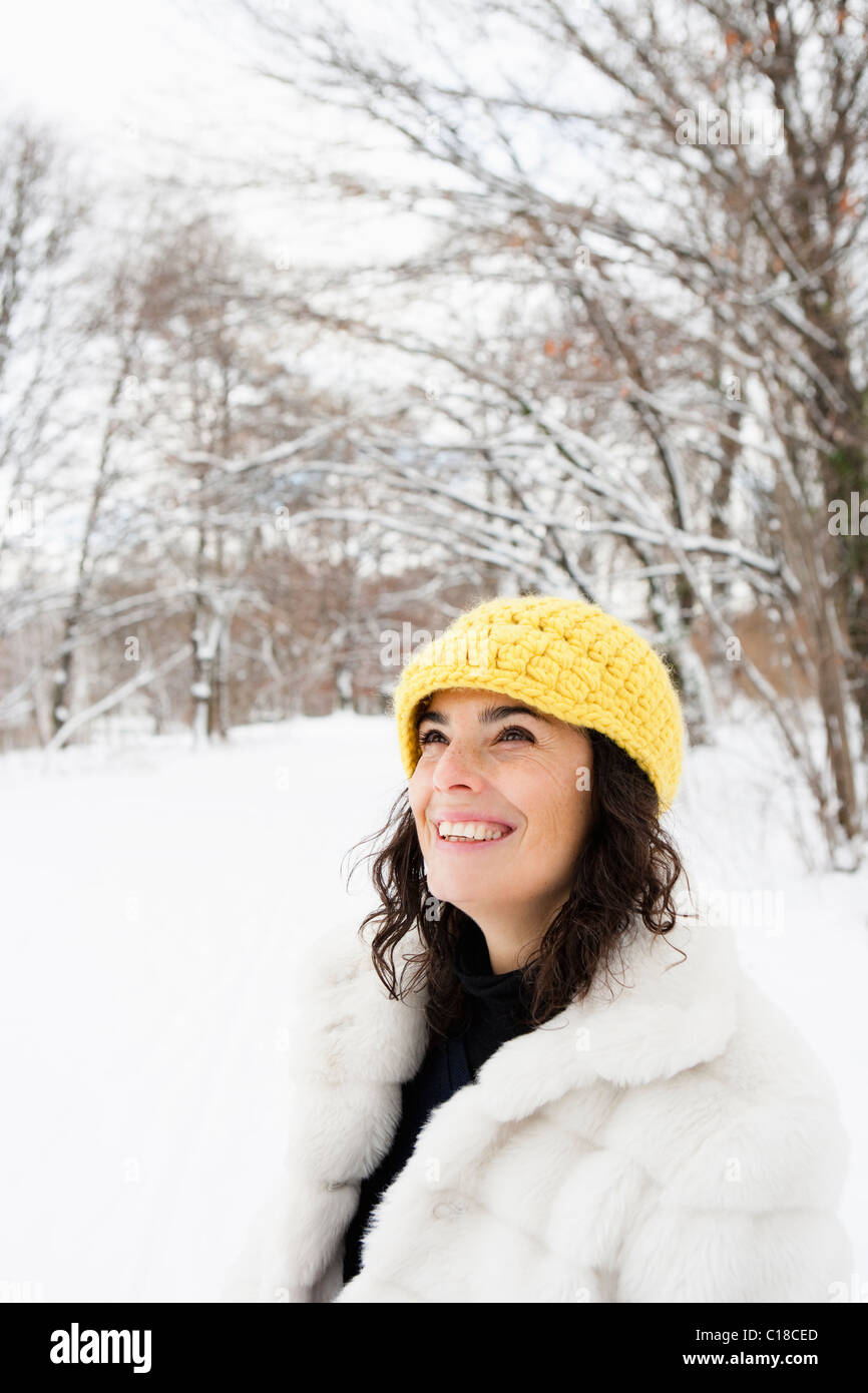 Woman with yellow cap standing in woods Stock Photo - Alamy