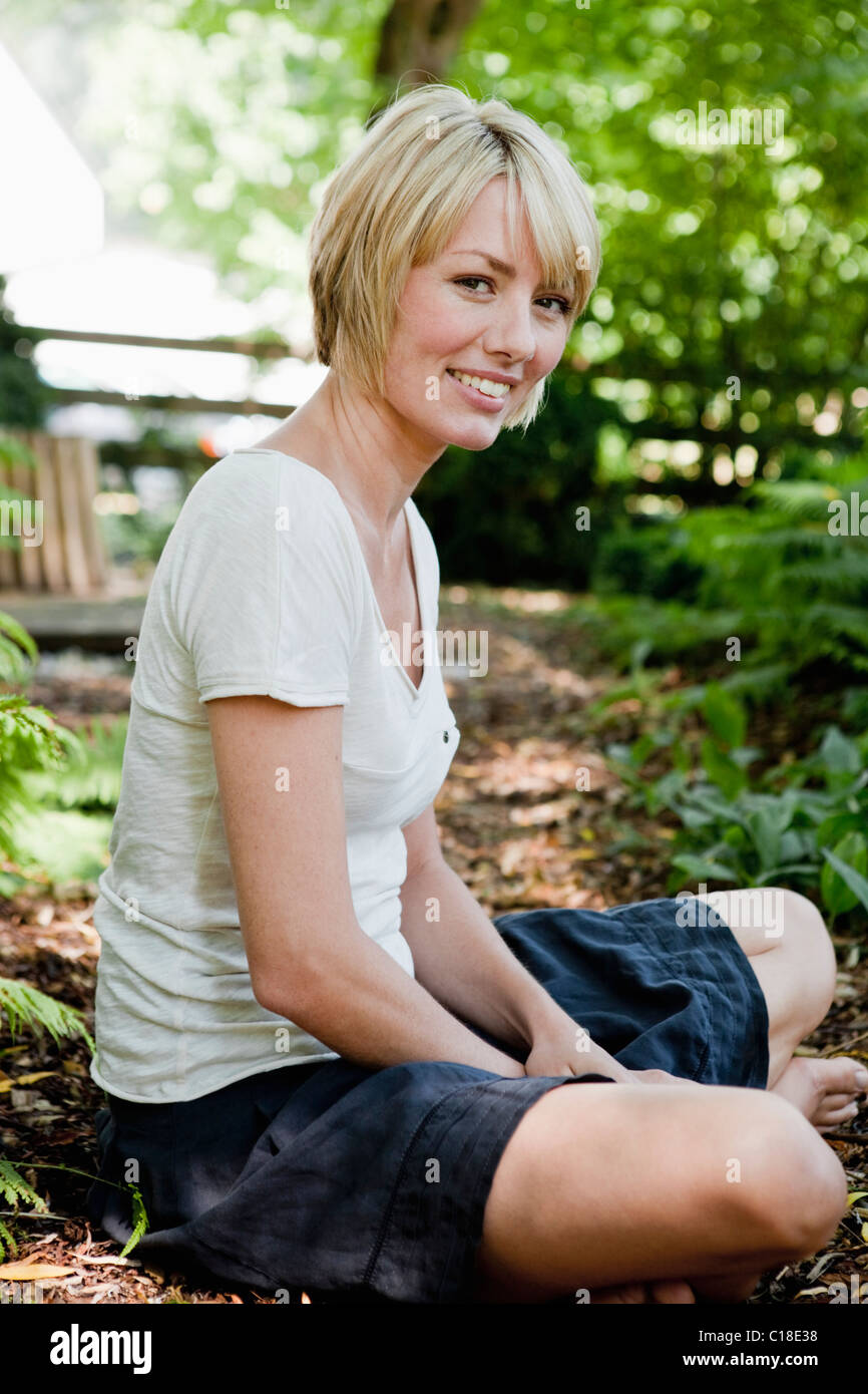 Young woman relaxing in garden Stock Photo - Alamy
