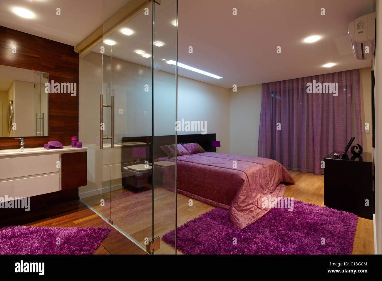 Bedroom With Bathroom Separated By Glass Walls Stock Photo