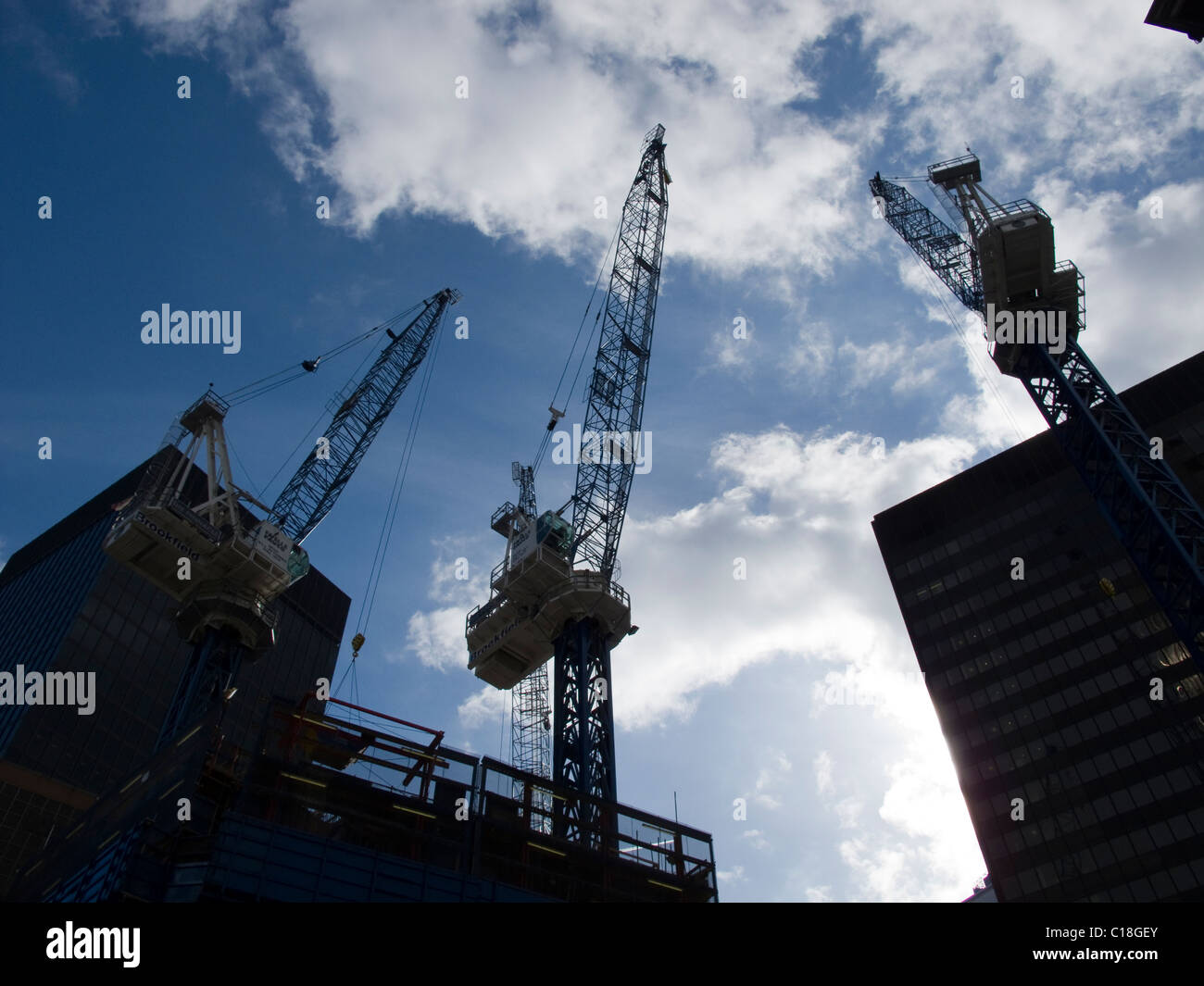 Tall cranes dominate the sky over the City of London on a construction site Stock Photo