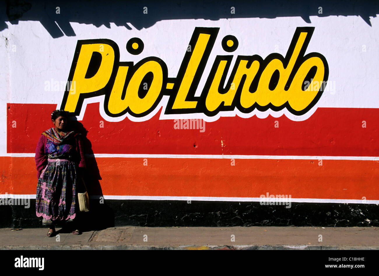 Guatemala, Western Cordillera, Quetzaltenango Department, Almolonga, Indian woman next to a advertising painting Stock Photo