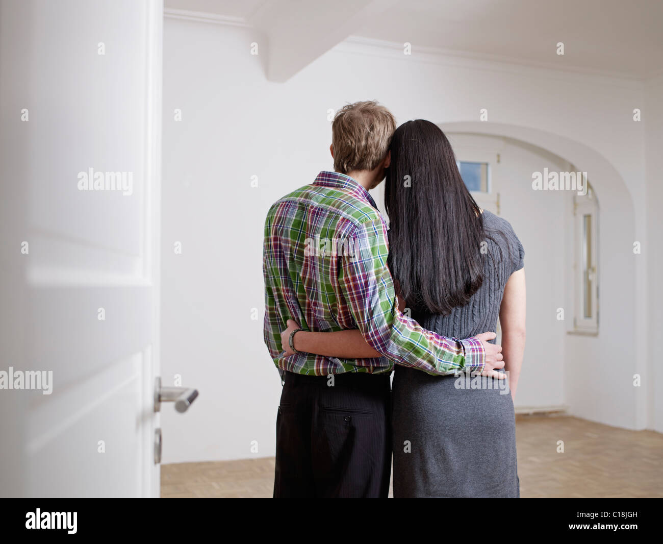 Couple in embracing in empty flat Stock Photo