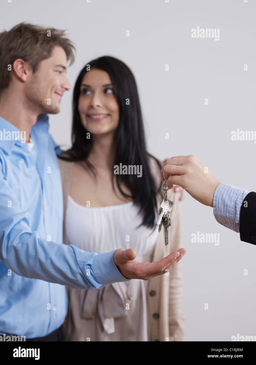 Estate agent hands over keys Stock Photo Alamy