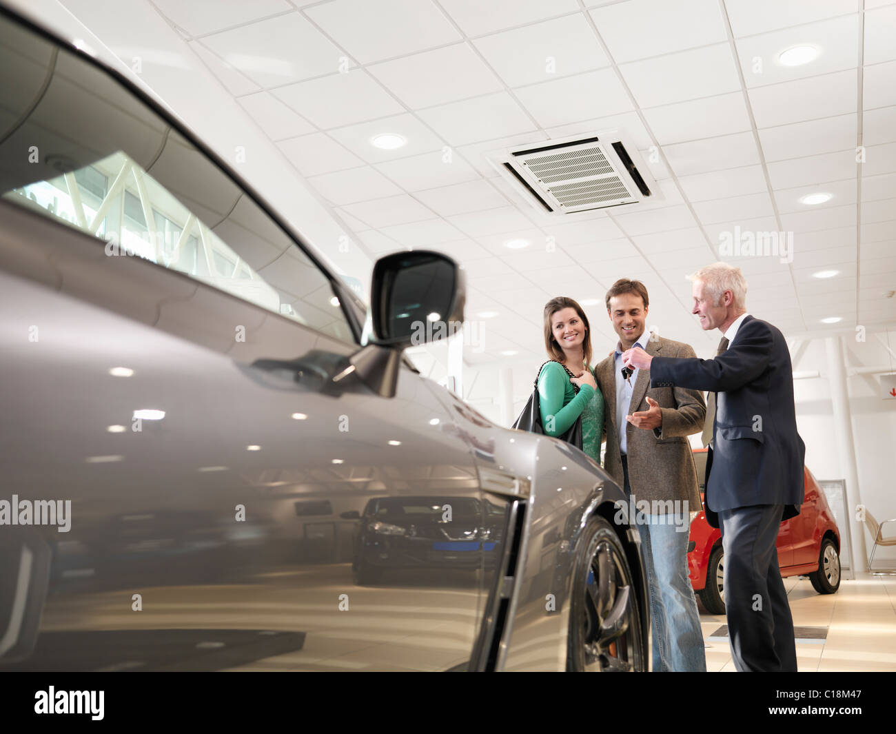 Salesman shows customers car Stock Photo